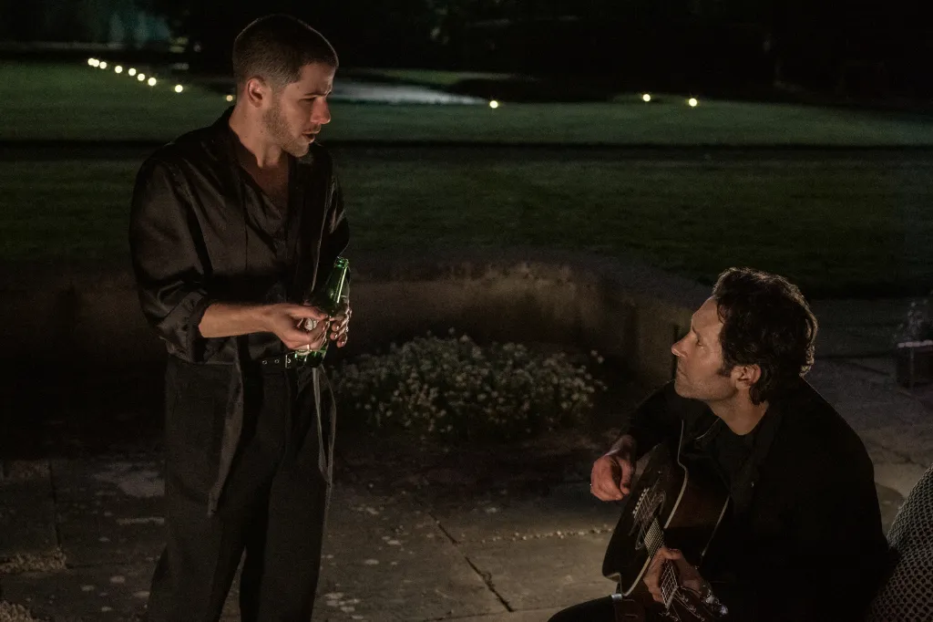 Os atores Paul Rudd e Nick Jonas em uma cena musical do filme Hit para Dois no palco.