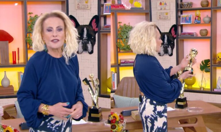 Ana Maria Braga sorridente segurando os troféus da premiação do SBT durante o programa Mais Você