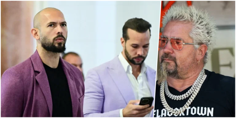 O apresentador Guy Fieri em um evento público, sorrindo e usando seus óculos característicos.
