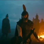 Christopher Nolan dirige cena prática de A Odisseia com dublês enterrados na areia.