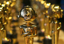 Fachada iluminada do Theatro Municipal do Rio de Janeiro durante a noite.