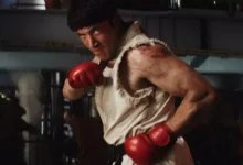 Logotipo do filme Street Fighter em destaque sobre um fundo urbano com néon e fumaça.