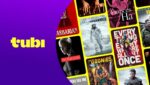 Tela com interface de streaming exibindo catálogo de filmes Tubi com destaque para Jogos Vorazes e Priscilla em seleção de maio